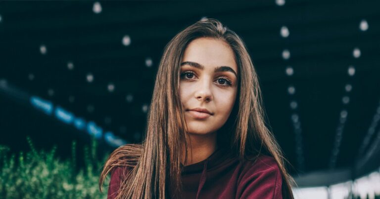 College-aged woman looking confidently ahead while navigating pregnancy in college and exploring her options for housing, support, and continuing her education.
